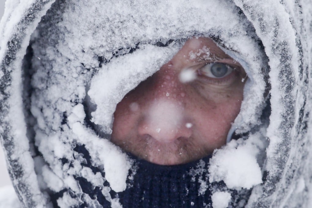 A snow-covered Jeremy Buckta snowblows his driveway in whiteout conditions during a snowstorm in Manitowoc, Wisconsin. Photo: AP