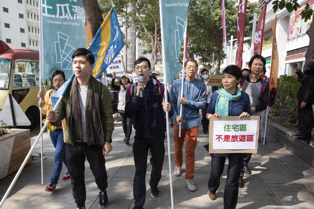 Residents march through To Kwa Wan on January 26 to protest against what they describe as a nuisance caused by unregulated numbers of tourists from the mainland. Photo: EPA