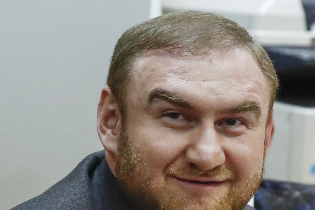 Russian lawmaker Rauf Arashukov smiles during hearings in a court in Moscow. Photo: AP