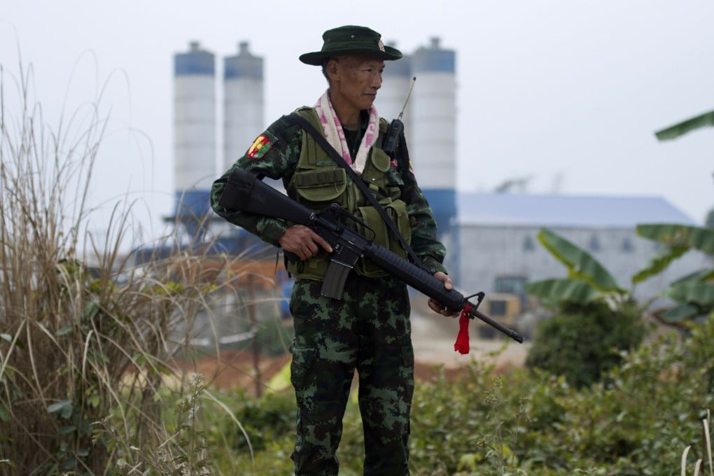 An armed Pan Say militiaman on a bridge in Muse in Shan state. Photo: AFP