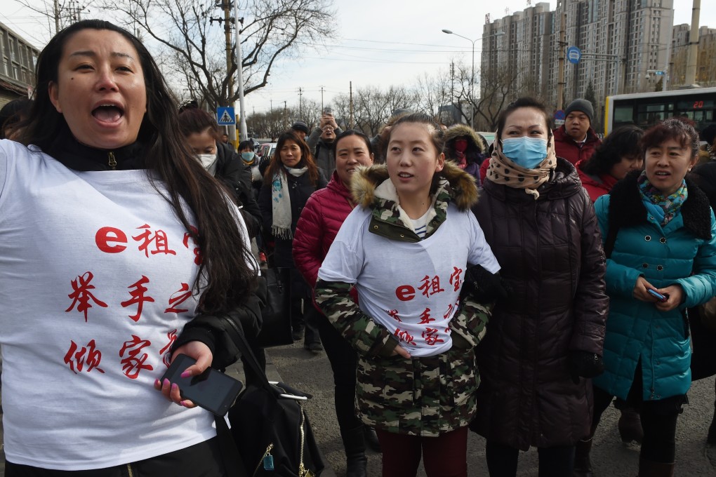 Investors in Chinese online peer-to-peer lender Ezubao chant slogans during a protest in Beijing in February 2016. Photo: AFP