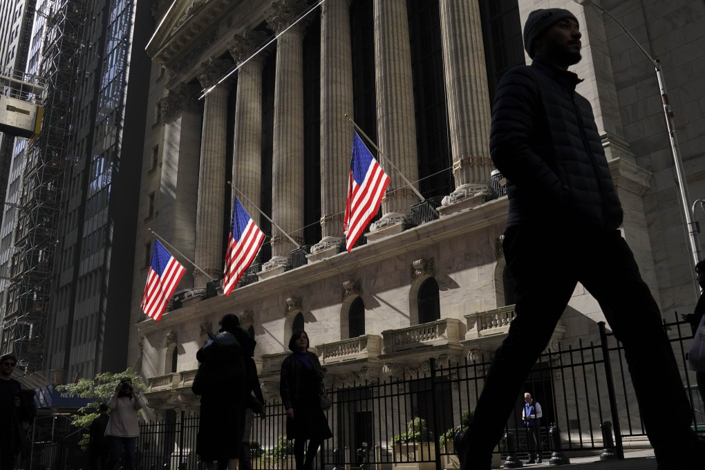 People walk past the New York Stock Exchange. The quantitative easing bluff has been called and financial markets know now that they can force monetary authorities to extend or increase stimulus by throwing a taper tantrum. Photo: Getty Images/AFP