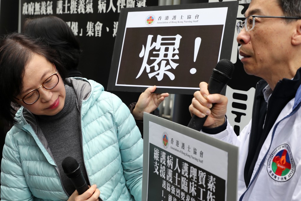 Hong Kong’s Food and Health secretary, Sophia Chan, reads a placard at a demonstration led by the Association of Hong Kong Nursing Staff against their heavy workload during the peak winter flu season, at the government headquarters in Admiralty on January 20. Photo: Robert Ng