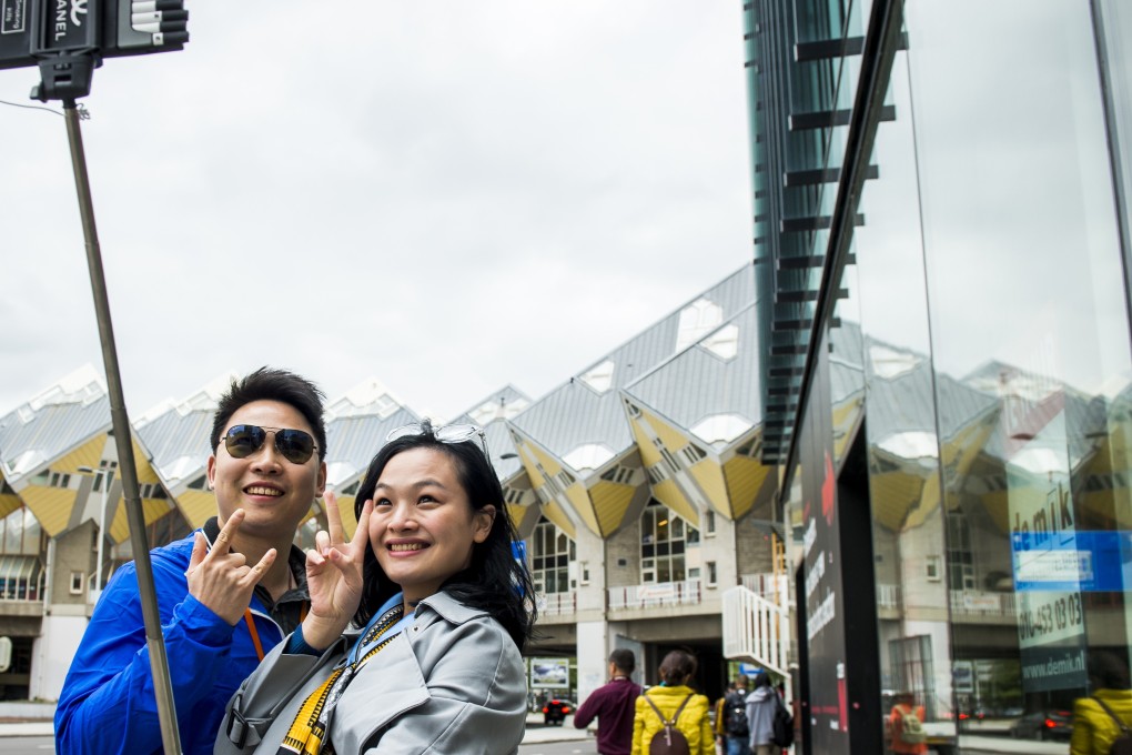 In 2018, Chinese travellers made 140 million outbound trips, a rise of 13.5 per cent from 2017, according to the China Tourism Academy. A Chinese couple earns social media bragging rights with a visit to Rotterdam, Netherlands, on May 25, 2015. Photo: AFP
