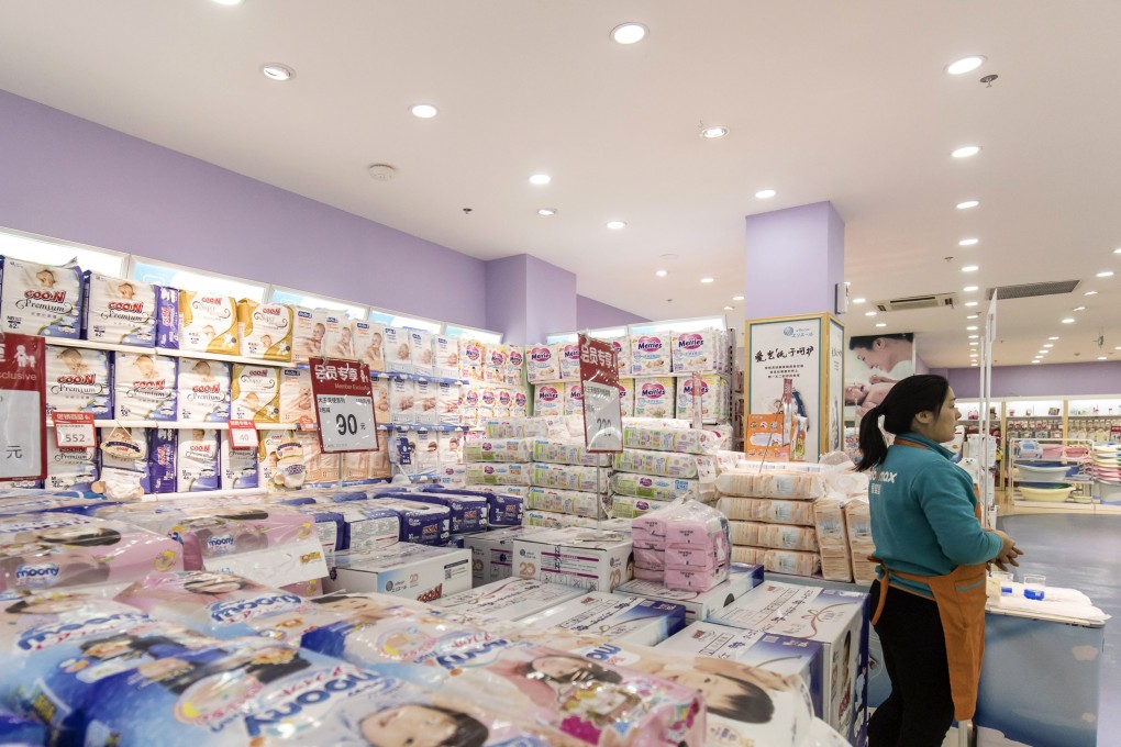 An employee next to diapers displayed for sale at a Shanghai Aiyingshi Co. Babemax store in Shanghai, China, in 2017. Photo: Bloomberg