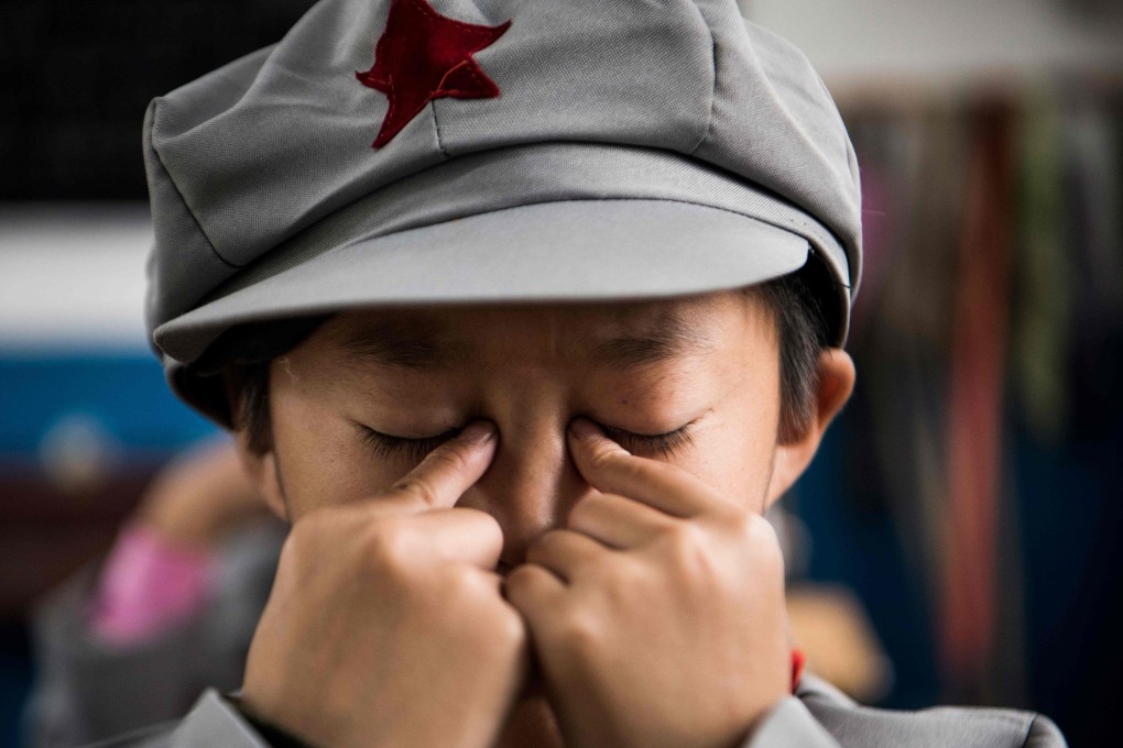A student does eye exercises at a “Red Army” elementary school in China’s Guizhou province. Part 1 optometrists in Hong Kong are the gatekeepers to detecting, diagnosing and treating avoidable eye and vision problems. Photo: AFP