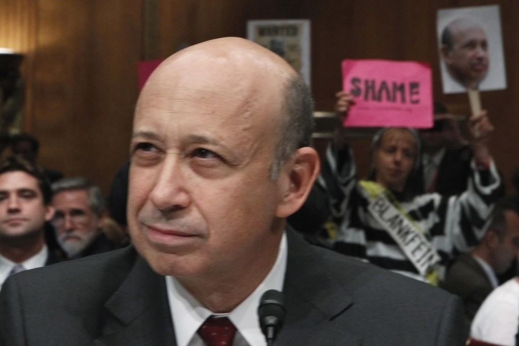 Protestors hold up signs as then-Goldman Sachs Chairman and CEO Lloyd Blankfein prepares to testify at the Senate Homeland Security and Governmental Affairs Investigations Subcommittee hearing on "Wall Street and the Financial Crisis: The Role of Investment Banks" in Washington in 2010. Photo: Reuters