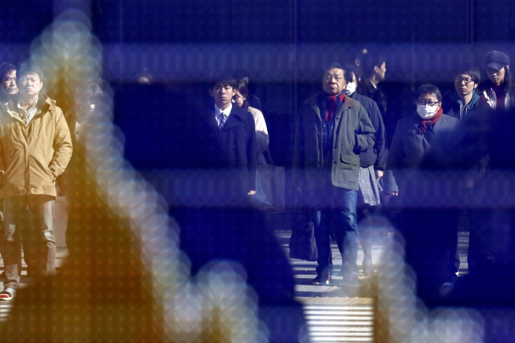 Pedestrians are reflected in a stock market indicator board in Tokyo, Japan, on January 29. Economics can no longer be allowed to run riot, independent of politics, sociology and ecology. It just does not add up. Photo: EPA-EFE