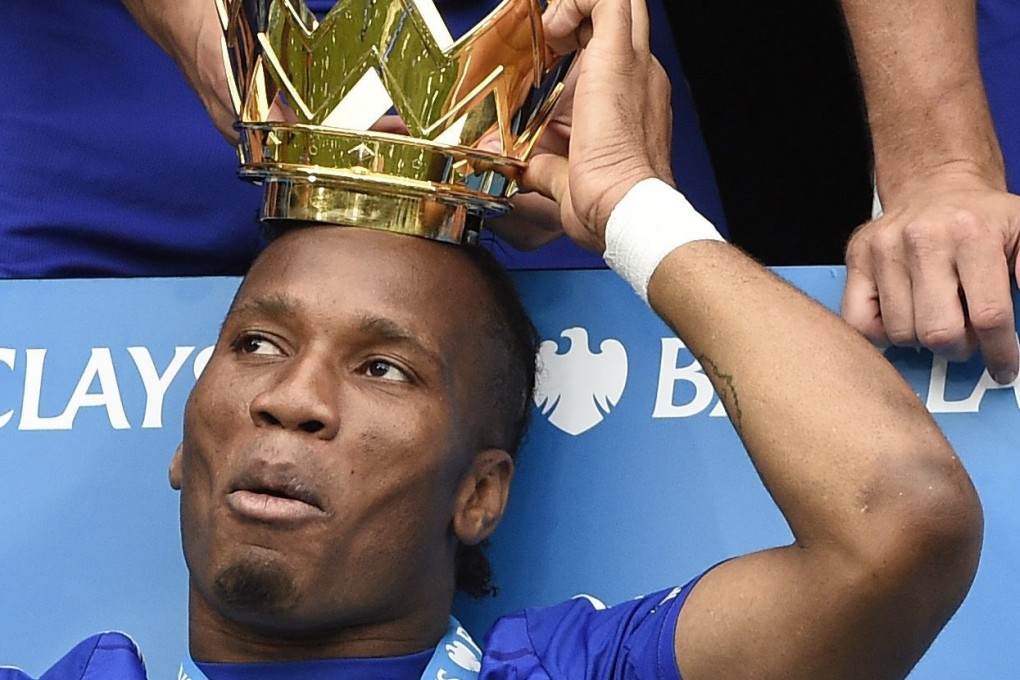 Chelsea player Didier Drogba celebrates with the English Premier League trophy in 2015. Photo: EPA