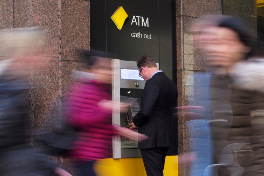 A man banks at a Commonwealth Bank ATM in Sydney, Australia. Photo: Reuters