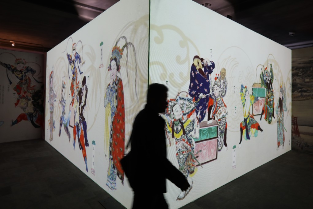 A visitor walks past a digitalised display of Chinese opera figures at an immersive exhibition at the Palace Museum in Beijing, China. Photo: Simon Song