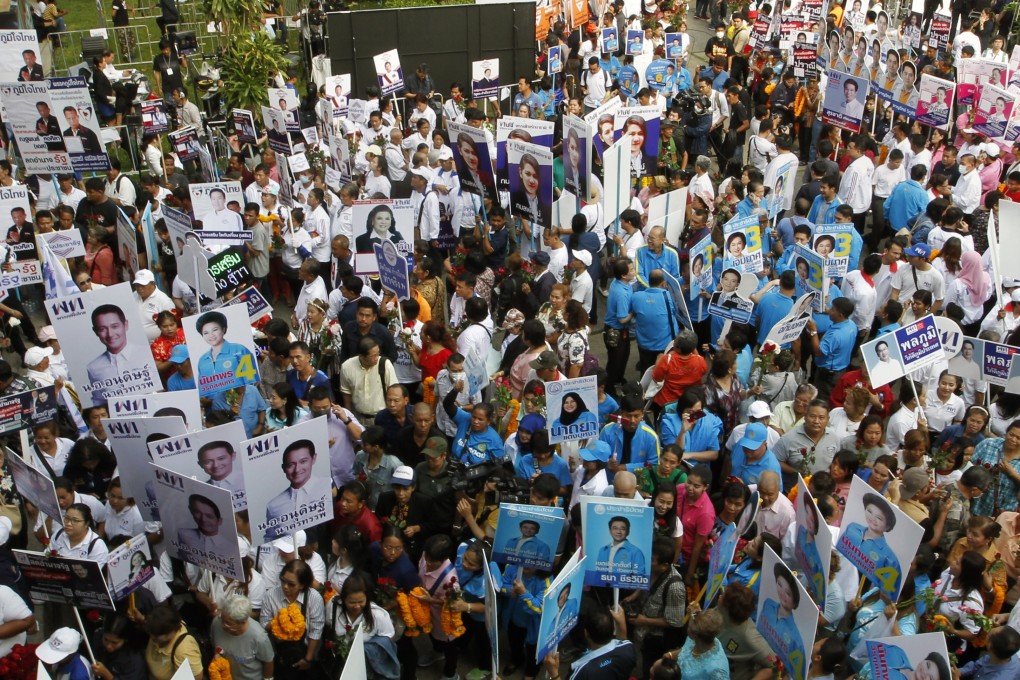 Supporters of political parties hold campaign banners at a candidate registration event in Bangkok. Photo: EPA