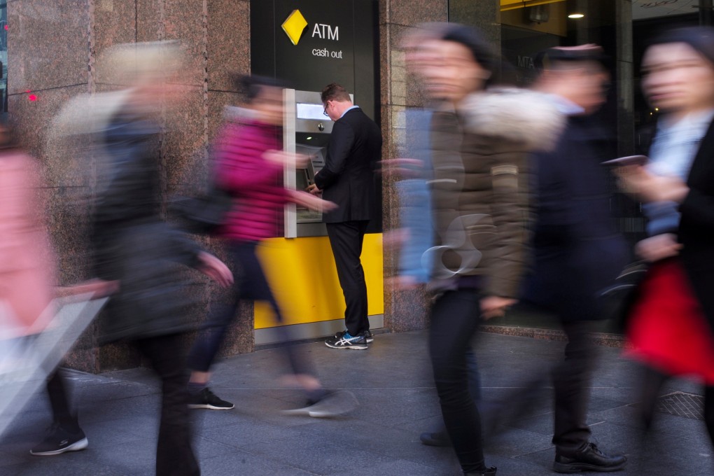 A man banks at a Commonwealth Bank automatic teller machine in Sydney. Photo: Reuters