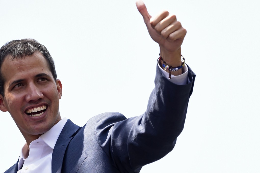 Opposition leader Juan Guaido gives his thumb up to thousands of supporters in Caracas on February 2. Photo: AFP
