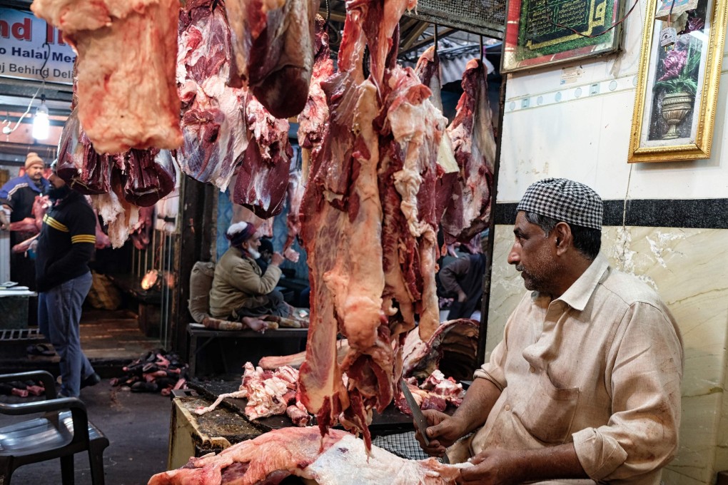 An Indian butcher cuts buffalo meat as he waits for customers in his shop at a meat market in the old quarters of New Delhi. Photo: AFP