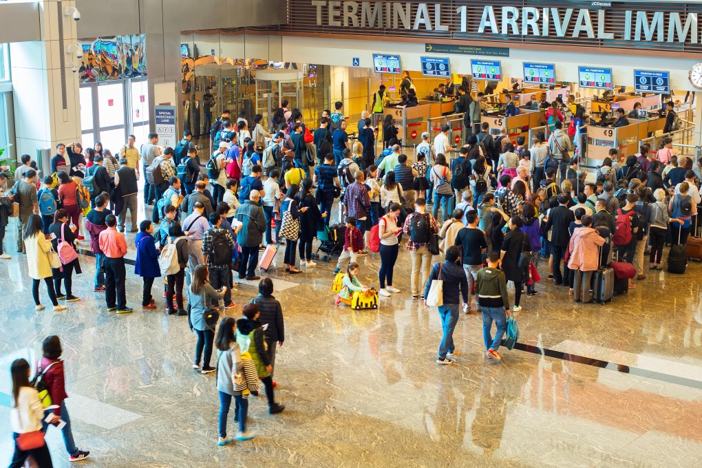 Visitors lining up for entry clearance at Singapore’s Changi airport. Photo: Alamy