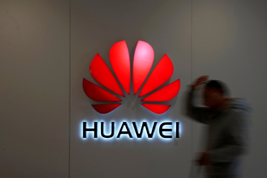 A man walks by a Huawei logo at a shopping mall in Shanghai in this file photo. Photo: Reuters