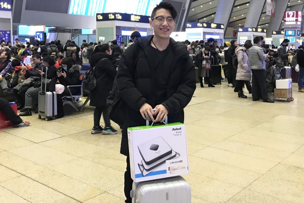 Technology and tradition meet in the form of a mopping robot, the Lunar New Year gift choice of a homeward-bound passenger at Shenzhen railway station. Photo: Tencent News