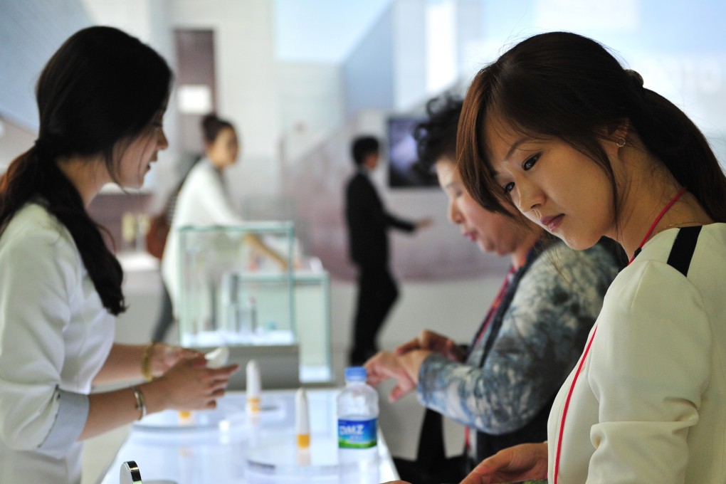 A customer examines various products at the Korea Beauty and Cosmetic Expo. Photo: AFP