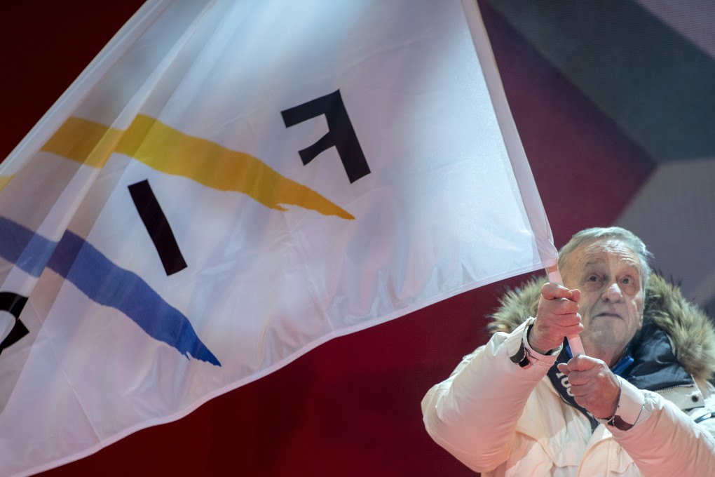 Gian Franco Kasper, president of the International Ski Federation, waves the FIS flag during the opening ceremony of the FIS Alpine Skiing World Championships in Are, Sweden, on Monday. Photo: EPA