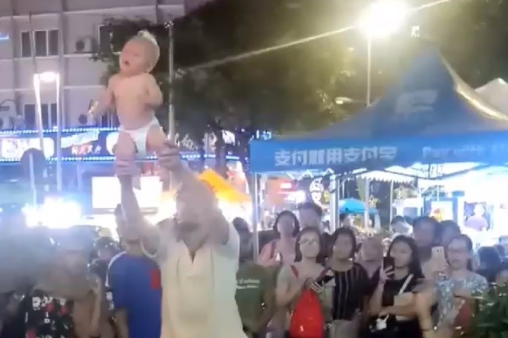 A still from the video showing the Russian man swinging his baby around in Kuala Lumpur. Photo: Facebook