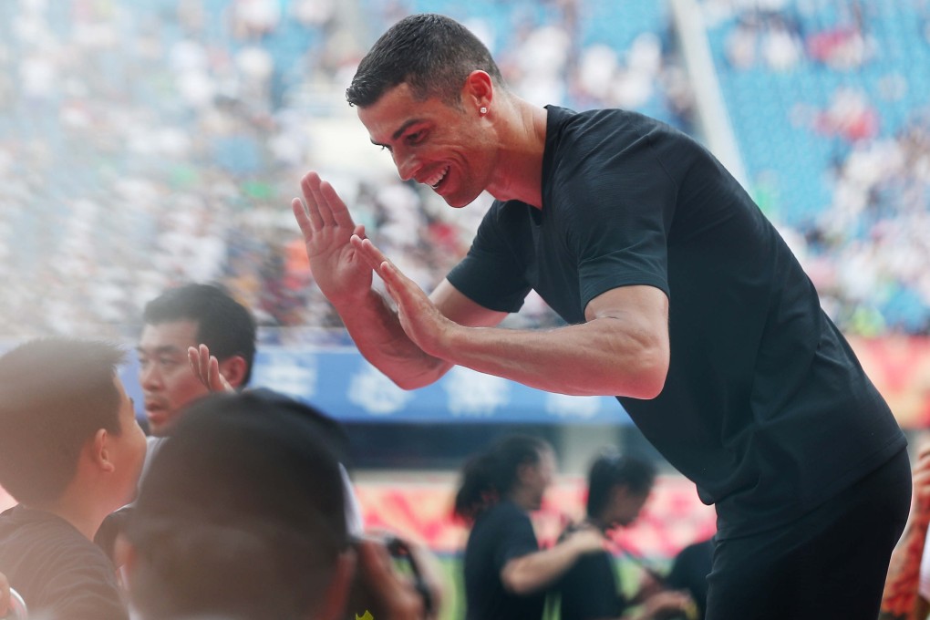 Cristiano Ronaldo plays with young fans during his visit to Beijing with Juventus in July. Photo: Xinhua