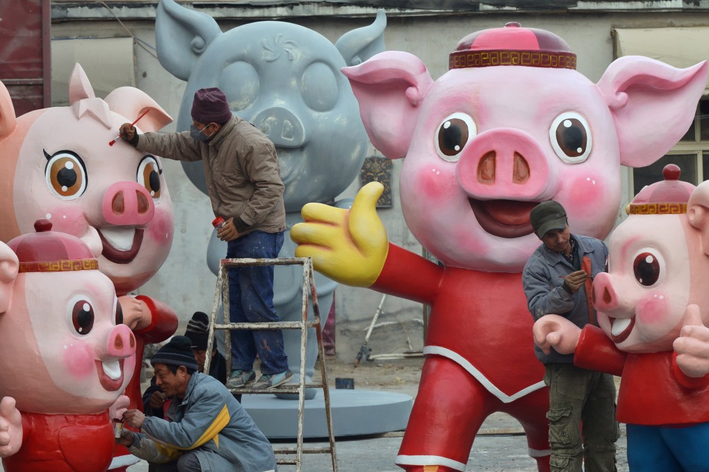 Men work on pig sculptures in preparation for the upcoming Lunar New Year, in Changping district of Beijing. Photo: Beijing Youth Daily via Reuters