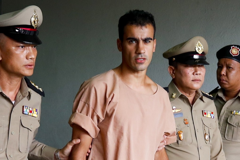 Bahraini soccer player (centre) being escorted by Thai prison officers following an extradition hearing at the Criminal Court in Bangkok on 4 February. Photo: EPA