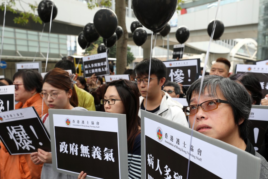 Members of the Association of Hong Kong Nursing Staff carry black balloons to symbolise their plight, as they protest on January 20 against the overloading of the public health system during the winter flu season. Photo: Robert Ng