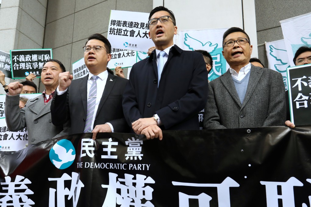 Lawmakers (from left) Wu Chi-wai, Andrew Wan Siu-kin and Lam Cheuk-ting, and Chan Kin-man, co-founder of the Occupy Central movement, protest at the police headquarters in Wan Chai on December 18. Wan and Lam were reporting to the police on charges related to rowdy behaviour during a Legislative Council meeting on June 13, 2018. Photo: Dickson Lee