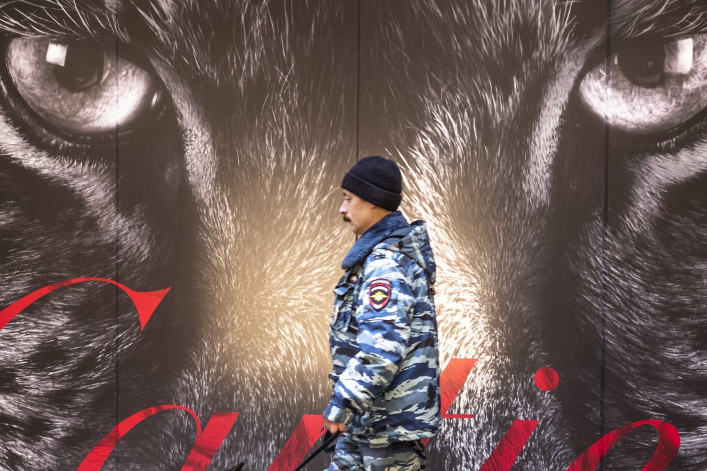 A Russian police officer patrols the store GUM, at Red Square in Moscow, on Tuesday, after dozens of fake bomb calls prompted authorities to evacuate shopping malls, schools and other buildings. Photo: AP