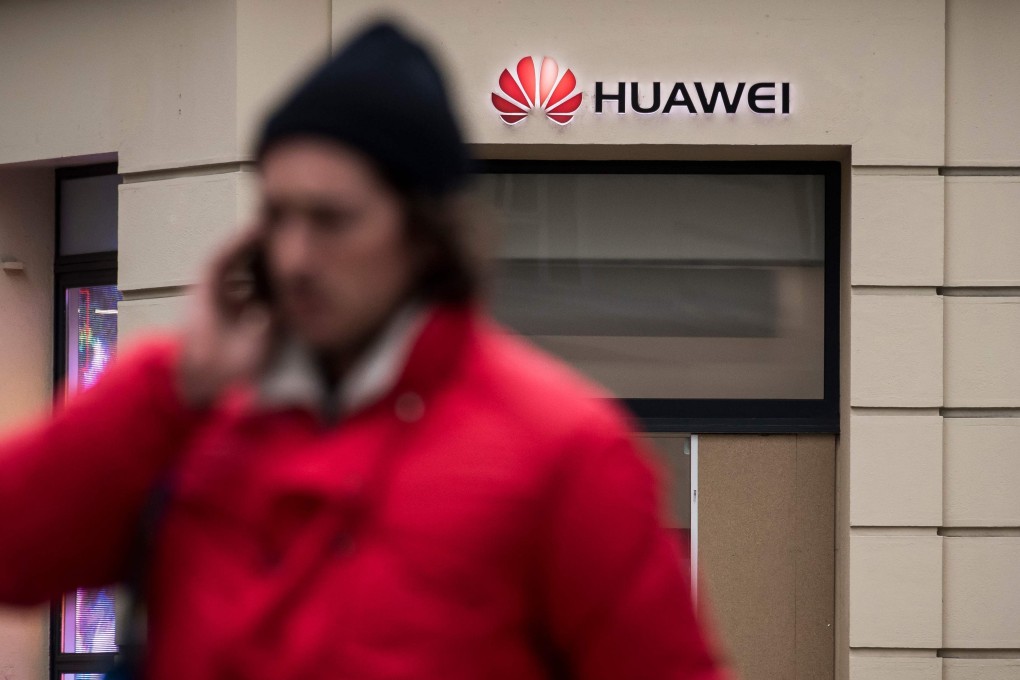 People pass by a Huawei store in Paris on Monday. Photo: AFP