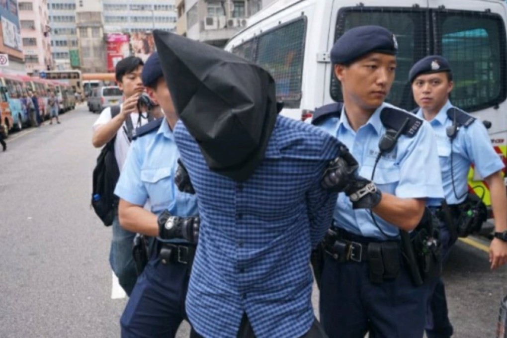 Police take away a man, believed to be South Asian, after he and an accomplice tried to rob a mainland Chinese tourist of a rucksack containing HK$80,000. Some Hong Kong media play up arrests of asylum seekers to feed the notion that they are a risk to society, even though crime rates among them are comparatively much lower. Photo: Facebook