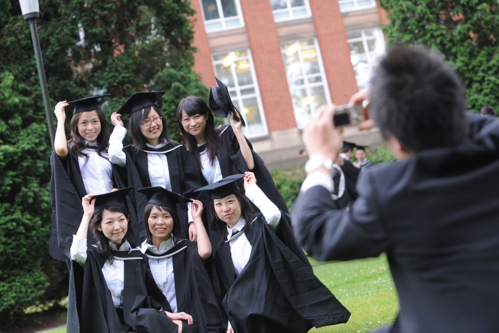 Overseas students pose for a photog on Graduation day at Birmingham University, UK. File photo: Alamy