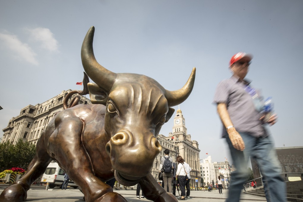 A pedestrian walks past the Bund Bull statue in Shanghai, China on October 24, 2018. Photo: Bloomberg