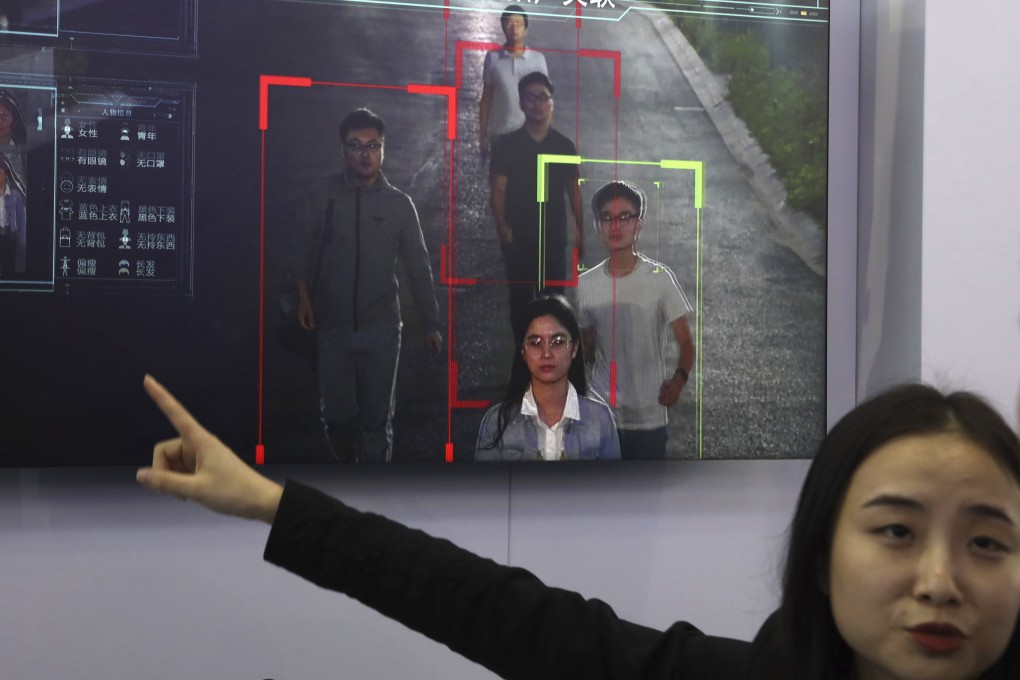 A saleswoman introduces human identification technology from state-owned surveillance equipment manufacturer Hikvision on a monitor at Security China 2018 in Beijing. Photo: AP