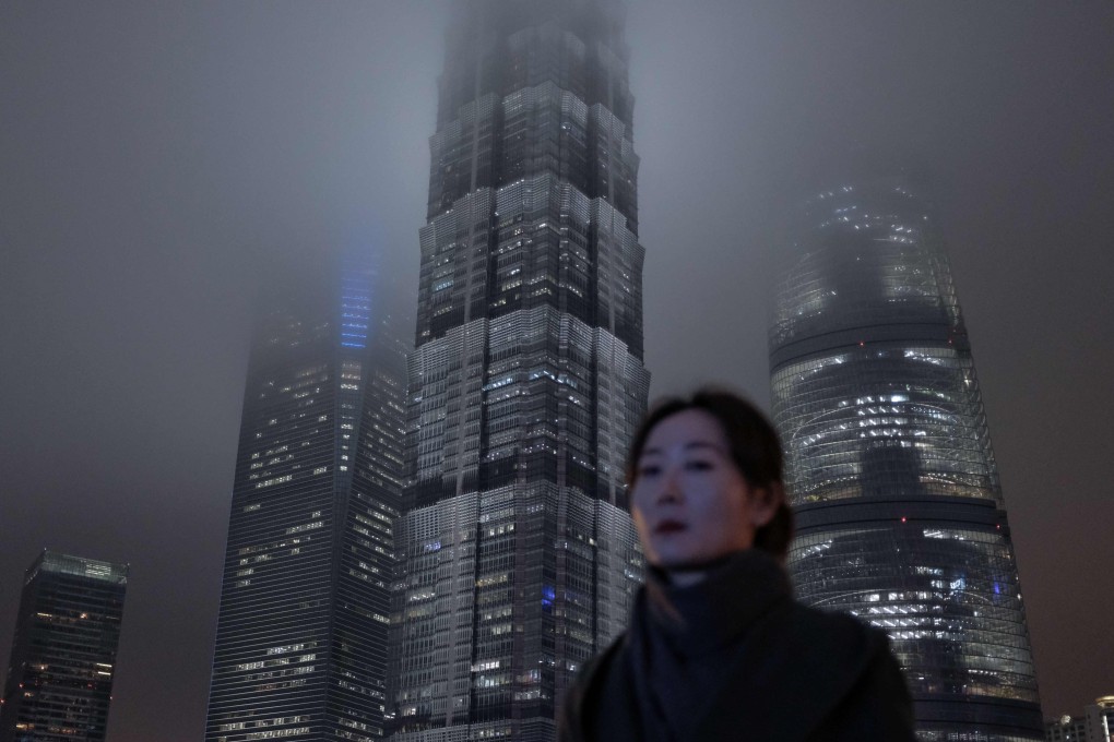 A woman walks through Shanghai’s Lujiazui financial district. As China’s economic growth slows, the Federal Reserve has put its interest-rate-hiking campaign on hold. Photo: AFP