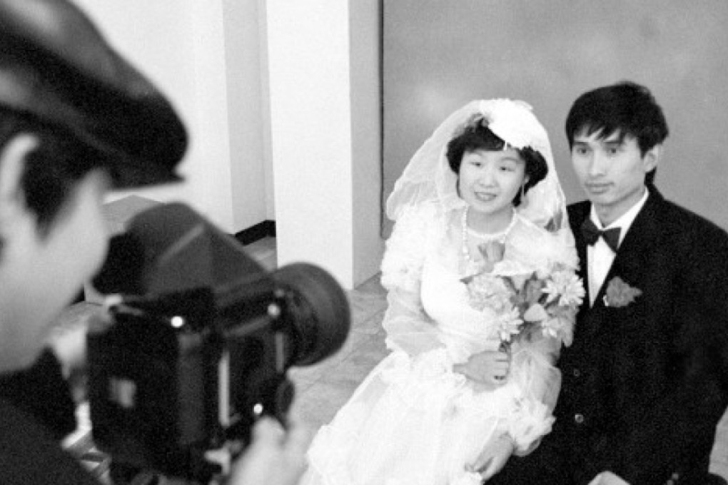 A couple have their picture taken at China Photo Studio. Photo: Handout