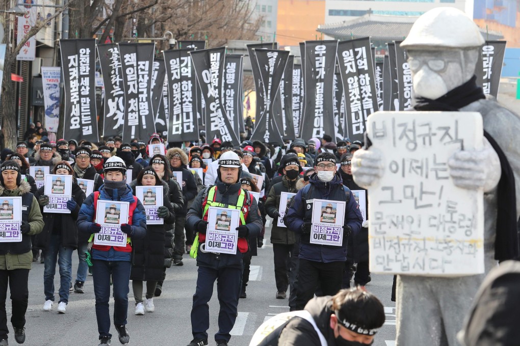 People march to honour a worker crushed to death at a coal plant. Photo: AFP