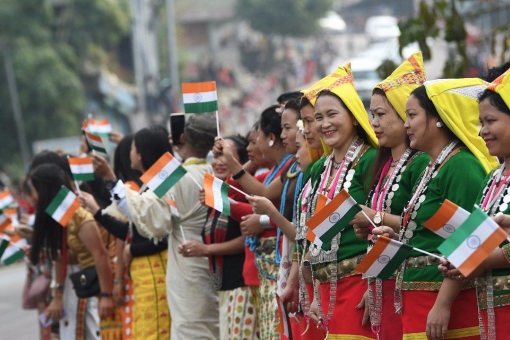 People in Arunachal Pradesh wave flags to welcome Indian Prime Minister Narendra Modi. Photo: Twitter