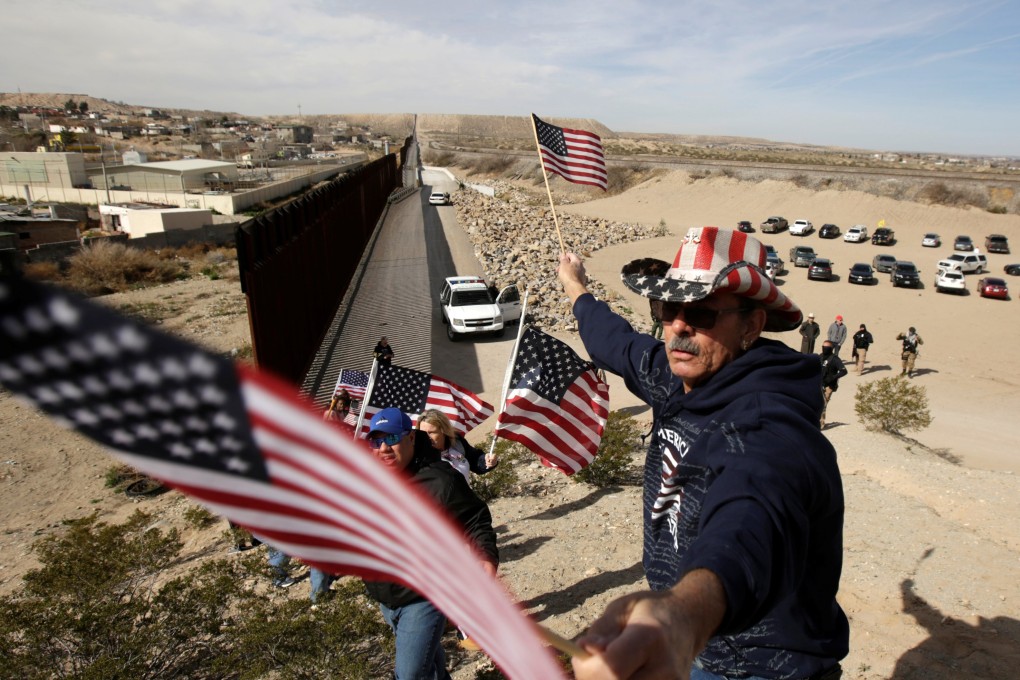 US demonstrators hold flags at the open border to make a human wall in support of Trump’s new border wall between the US and Mexico in Ciudad Juarez, Mexico on February 9, 2019. Photo: Reuters