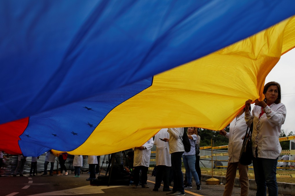 A Venezuelan doctor attends a gathering at the entrance of a warehouse where humanitarian aid for Venezuela is being stored near the Tienditas cross-border bridge between Colombia and Venezuela in Cucuta, Colombia February 10, 2019. Photo: Reuters