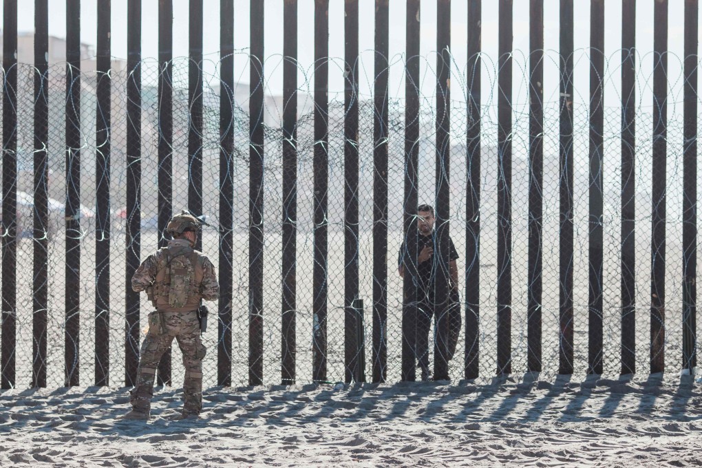 A US Border Patrol officer stands in front of the fence that divides the US and Mexico at Friendship Park in San Diego, California. File photo: AFP