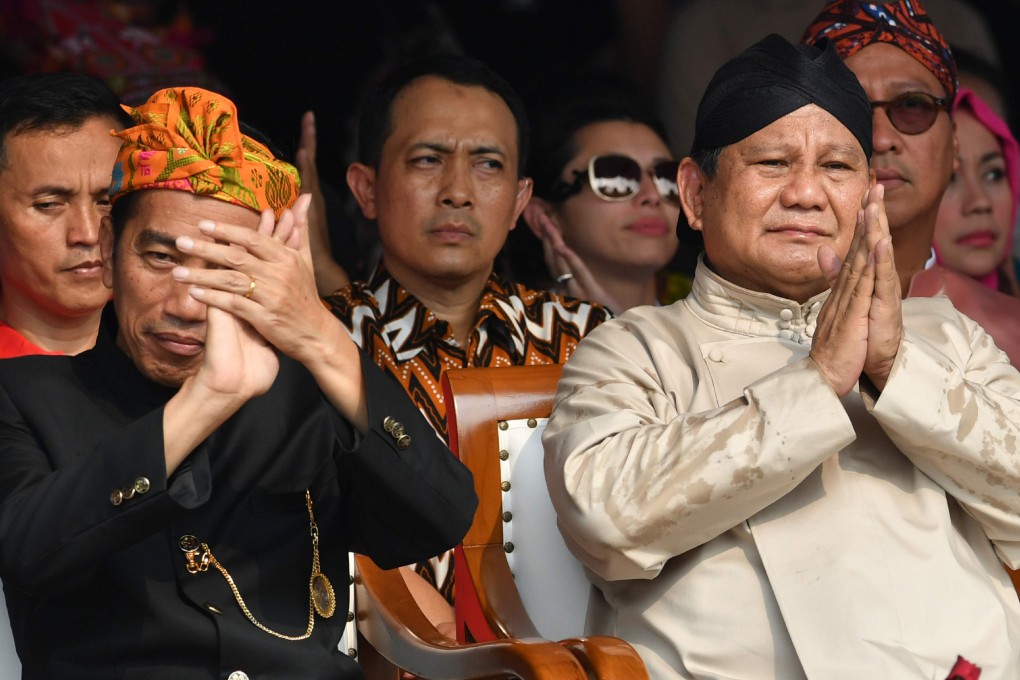 Indonesian President Joko Widodo (left) and his opponent in the presidential race, Prabowo Subianto, applaud at an event to kick off campaigning for the 2019 general election at the National Monument in Jakarta on September 23, 2018. Photo: AFP