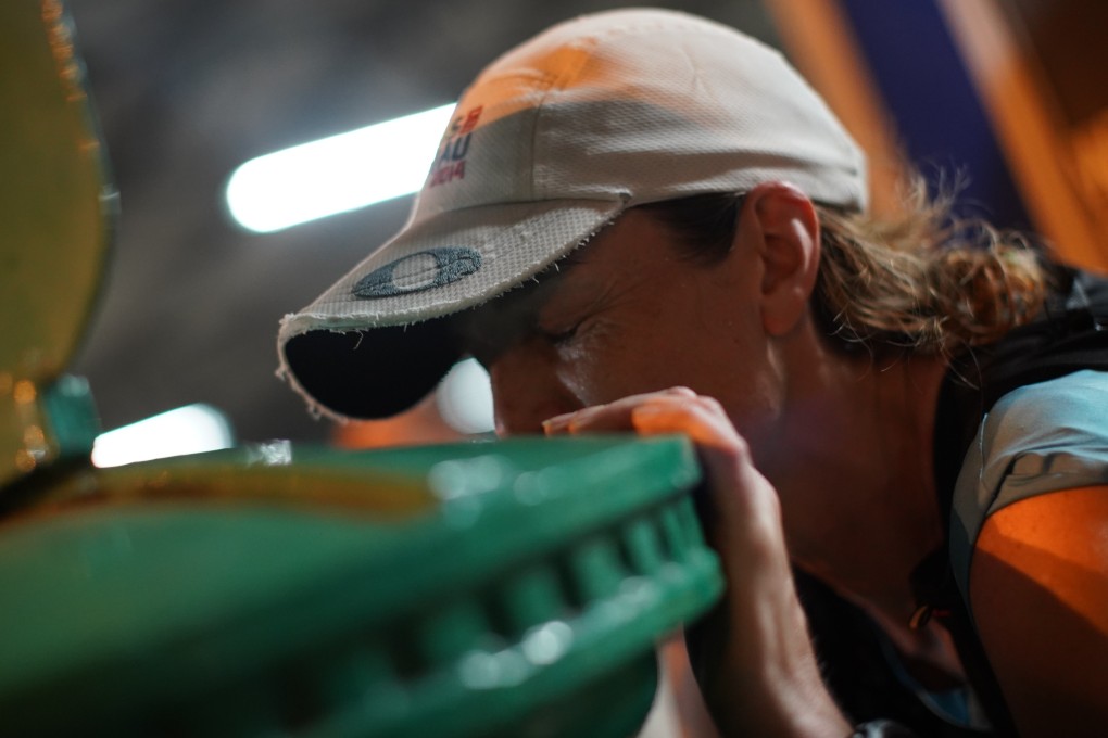Nikki Han kisses the green postbox in Mui Wo after becoming a ‘finisher’ of the Hong Kong Four Trails Ultra Challenge. Photo: Vincent Chan