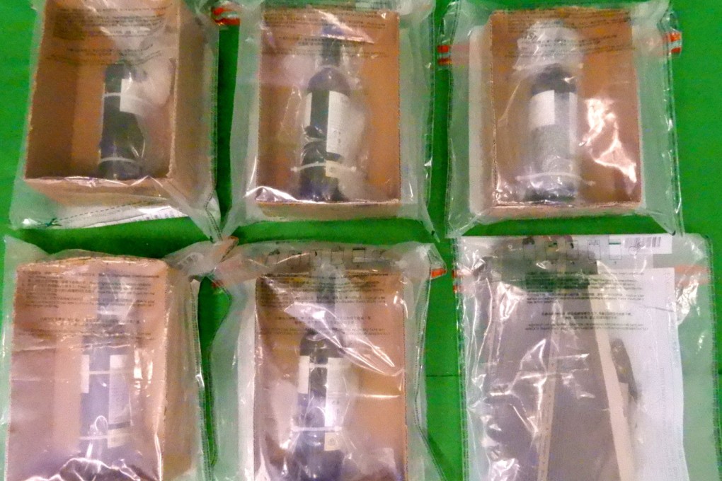 Customs officers seized wine bottles at Hong Kong International Airport containing four kilograms of suspected liquid cocaine with an estimated market value of about HK$4.8 million (US$615,000) during a comprehensive smuggling investigation. Photo: Handout