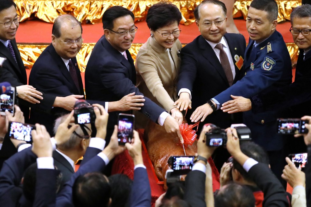 Carrie Lam (centre), flanked by Kenneth Lau (left) and Wang Zhimin, attends the Heung Yee Kuk spring reception in Sha Tin along with other top government officials. Photo: Nora Tam