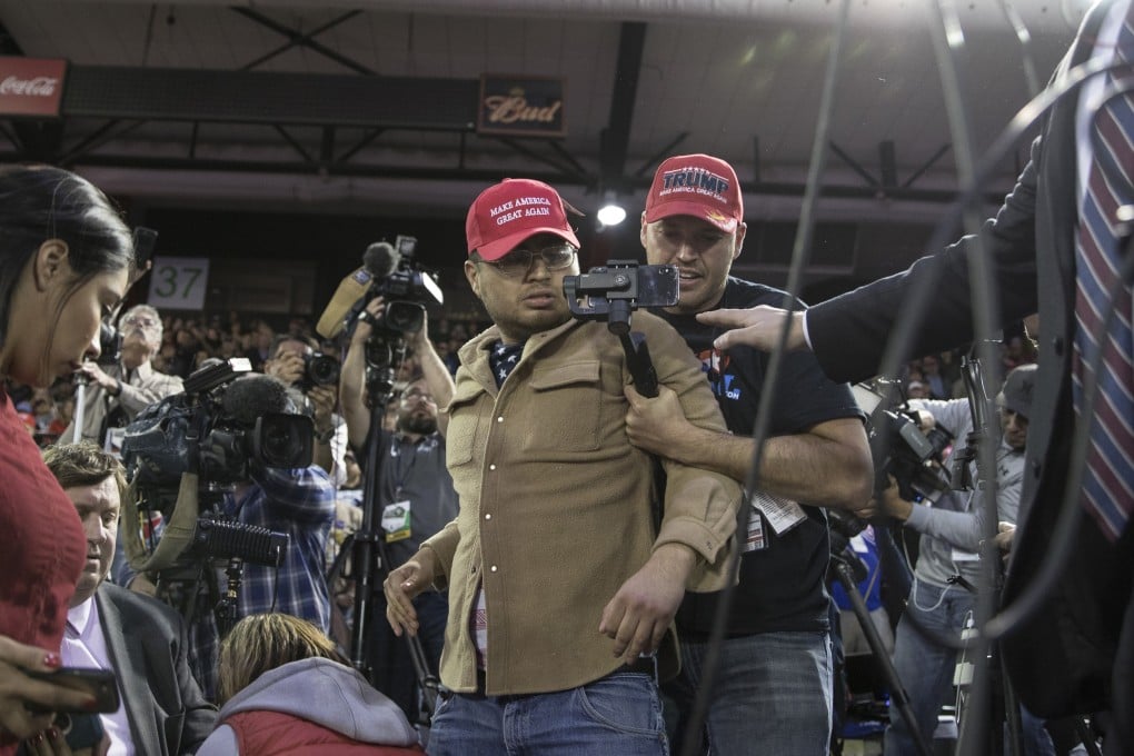 A Trump supporter, centre, is restrained after he attacked a BBC cameraman during a rally by US President Donald Trump in El Paso, Texas, on Monday. Photo: Bloomberg