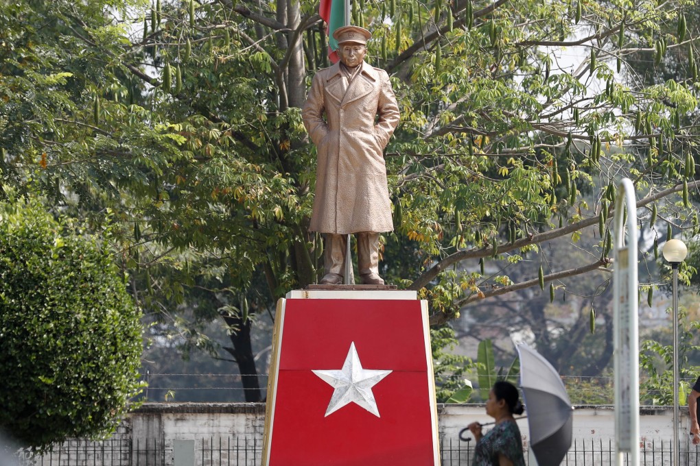 A woman walks in front of the General Aung San Statue at Thu Mingalar park in South Okkalapa township, Yangon. Photo: EPA