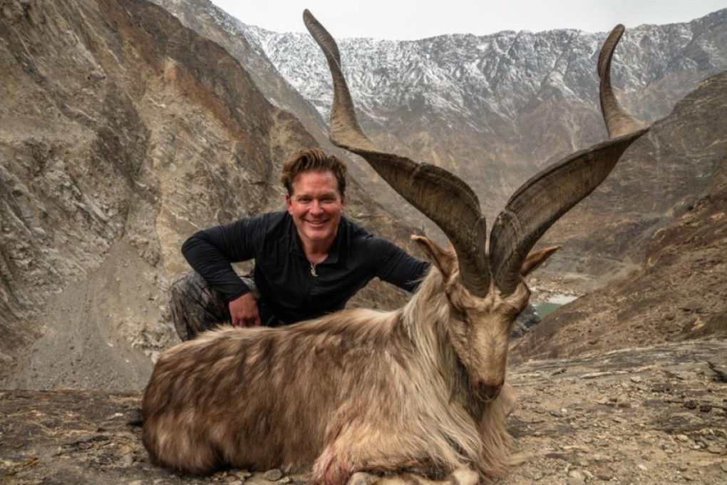 A hunter identified as Bryan Kinsel Harlan poses with his kill, a rare wild Astore markhor, in Pakistan. Photo: Supplied